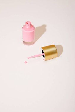 High angle view of opened bottle of pink nail polish on white background clipart