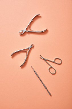 Top view of manicure instruments on coral background clipart
