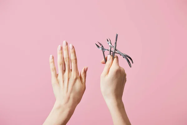 Cropped View Woman Holding Cuticle Pusher Nippers Isolated Pink — Stock Photo, Image
