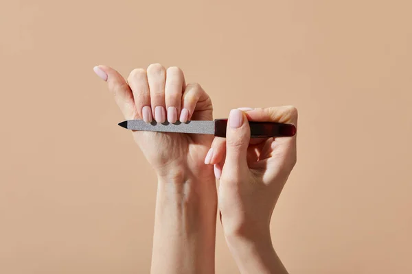 Vista Cortada Mulher Arquivando Unhas Isoladas Bege — Fotografia de Stock