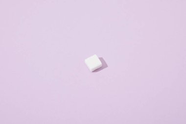 lump sugar cube on violet background with copy space clipart