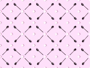 top view of lump sugar with black spoons on violet, seamless background pattern clipart