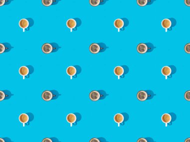 top view of cups of fresh coffee on blue, seamless background pattern clipart