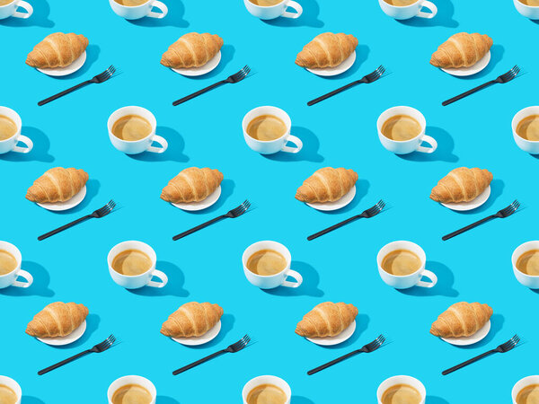 forks, fresh croissants on plates and coffee on blue, seamless background pattern