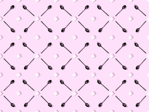 top view of lump sugar with black spoons on violet, seamless background pattern