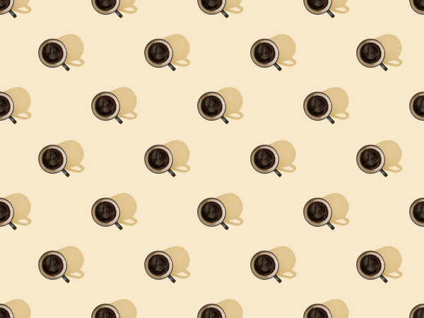 top view of cups of fresh coffee on beige, seamless background pattern
