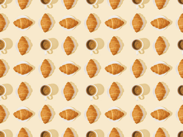 top view of croissants and coffee on beige, seamless background pattern