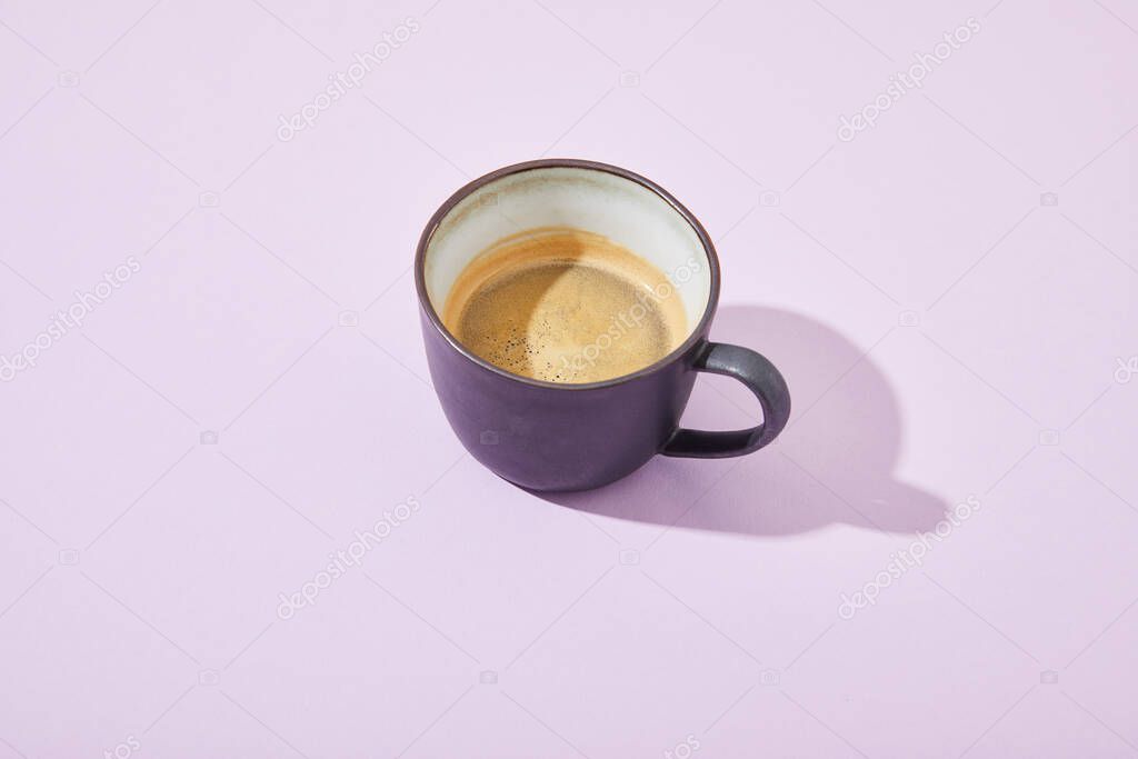 purple cup of coffee on violet background