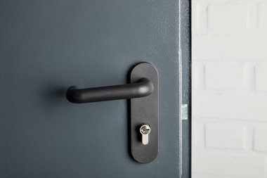 clean metal door with black handle after disinfection clipart