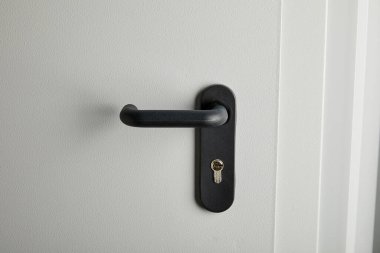clean grey metal door with black handle after disinfection clipart