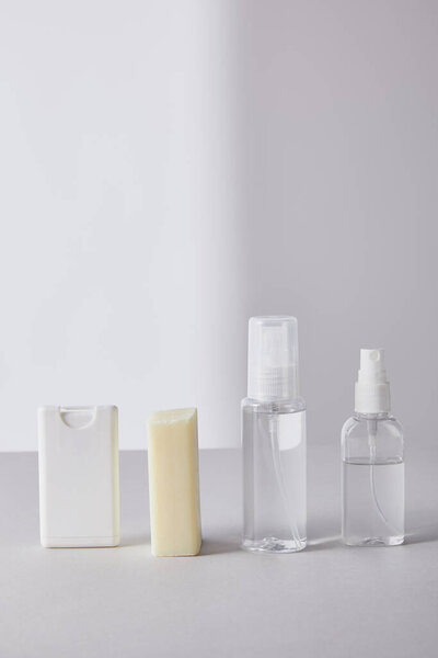 hand sanitizer in spray bottles and antibacterial soap on white background