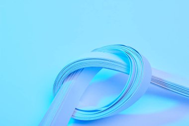 close up view of paper stripes on neon blue background clipart