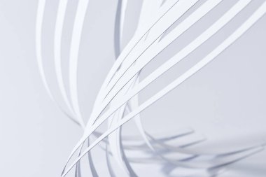 close up view of curved paper stripes on white background clipart