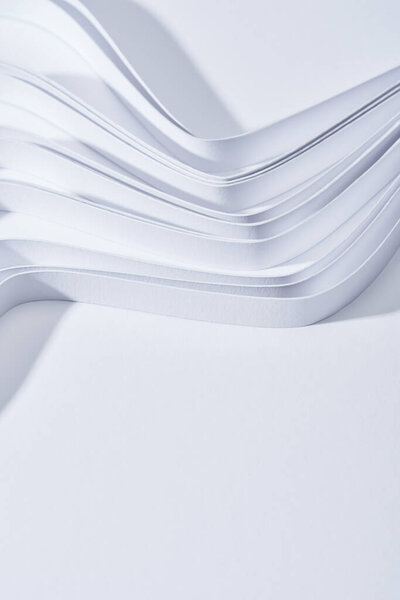 close up view of wavy paper stripes on white background