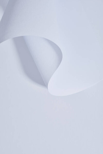 close up view of curved paper sheet on white background