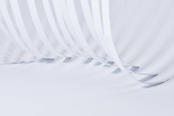 close up view of curved paper stripes on white background
