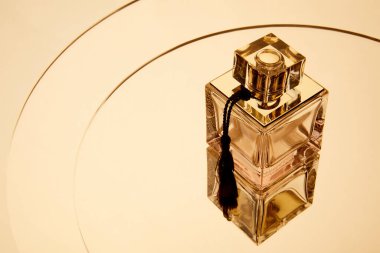 High angle view of aromatic perfume bottle on round mirror surface with reflection clipart