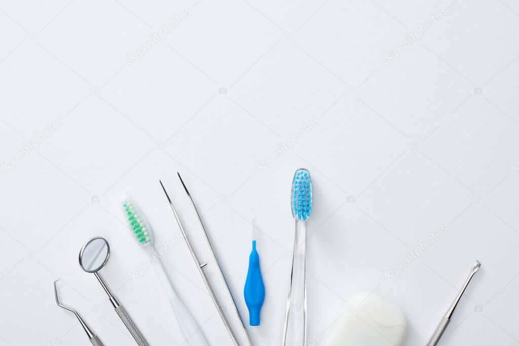 Top view of dental equipment for dental health and examining on grey background
