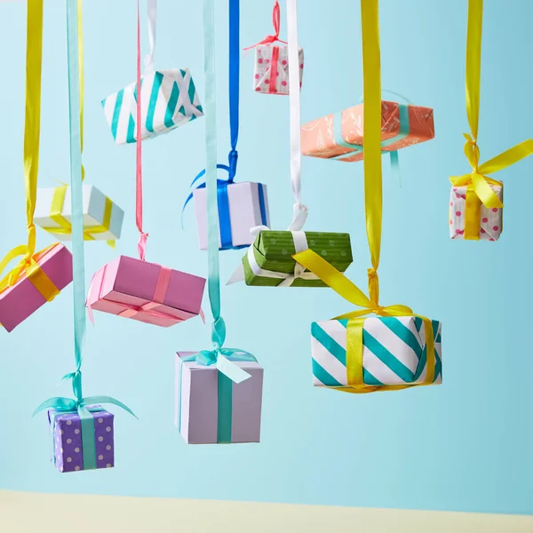 Festive Colorful Gift Boxes Hanging Ribbons Blue Background — Stock Photo, Image