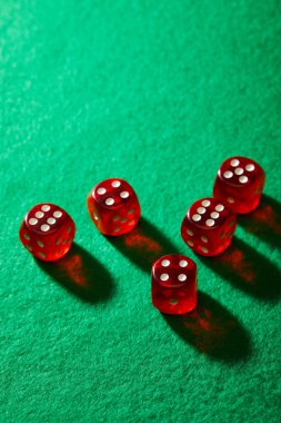 High angle view of red dice on green background clipart