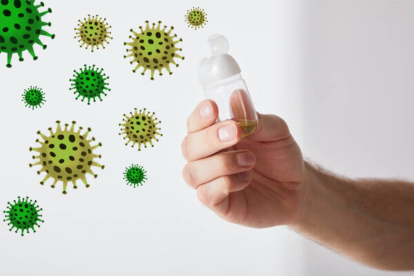 cropped view of man holding hand sanitizer on grey background, bacteria illustration