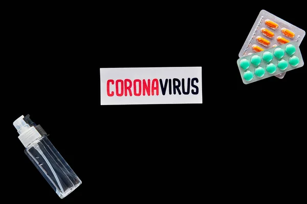 Top View Paper Coronavirus Lettering Pills Hand Sanitizer Isolated Black — Stock Photo, Image