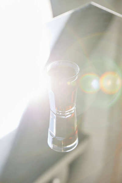 fresh soda in glass with reflection in sunlight