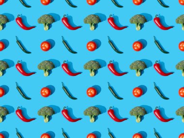 top view of fresh green broccoli, chili peppers and tomatoes on blue background, seamless pattern clipart