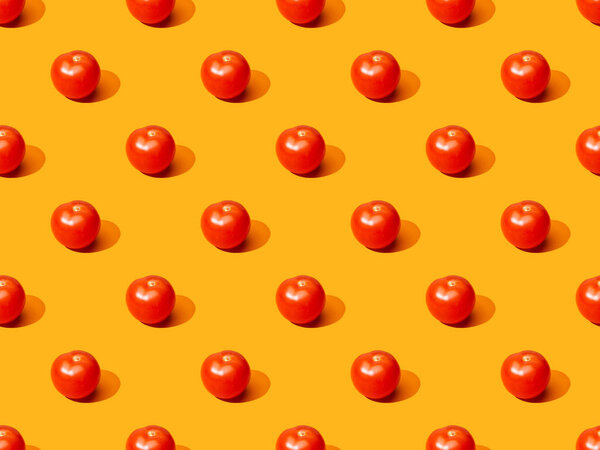 fresh tomatoes on orange colorful background, seamless pattern