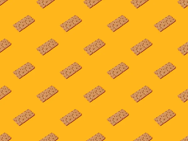 fresh crispbread on orange colorful background, seamless pattern