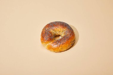 fresh baked bun on beige background clipart