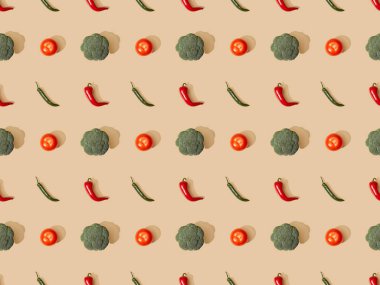 top view of red spicy chili peppers and jalapenos with broccoli and tomatoes on beige background, seamless pattern clipart