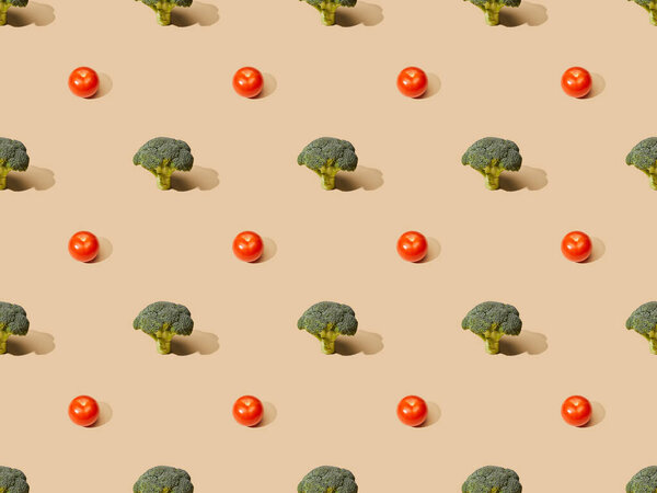 fresh green broccoli and tomatoes on beige background, seamless pattern