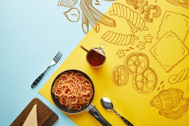 Domates soslu leziz spagetti ile düz yatıyordu mavi ve sarı arkaplanlı parmesan ve sebze resimli.