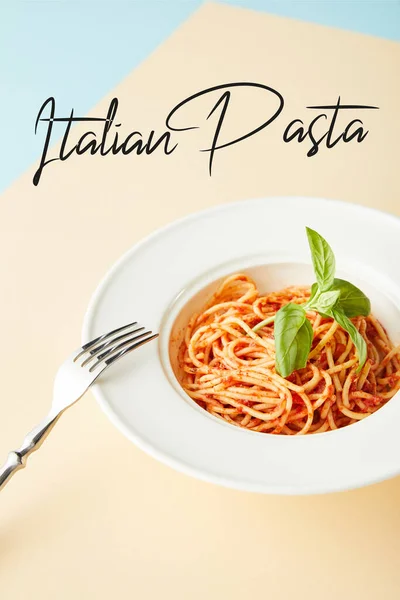 イタリアのパスタイラストと青と黄色の背景にフォークの近くのプレートにトマトソースとおいしいスパゲティ — ストック写真