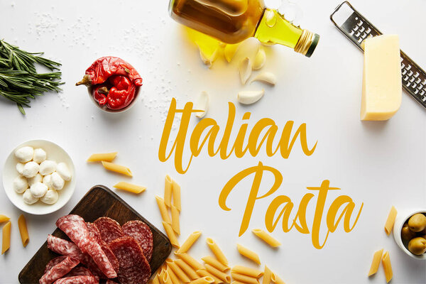 Top view of bottle of olive oil, meat platter, grater, pasta and ingredients on white, italian pasta illustration