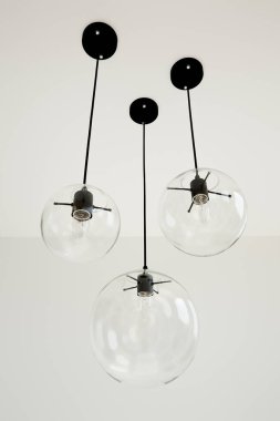 Incandescent light bulbs hanging on ceiling  clipart