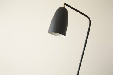 black modern lamp against white wall clipart