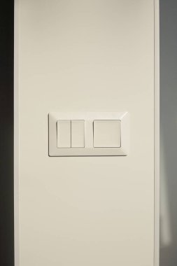 modern switch on white wall at home clipart