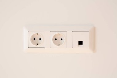 switch near power plugs on white  clipart