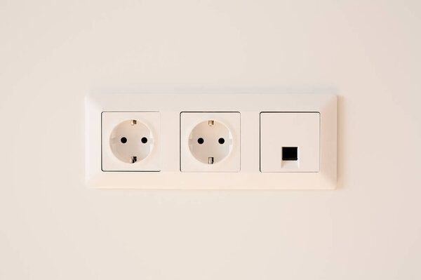 switch near power plugs on white 