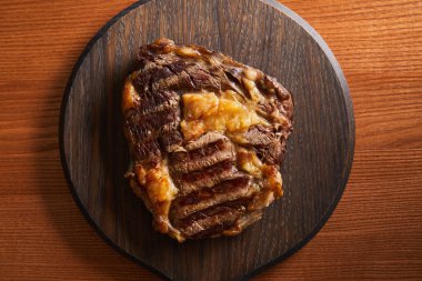 top view of tasty grilled steak served on wooden board clipart