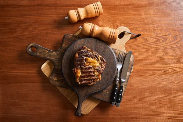 Top View Tasty Grilled Steak Served Wooden Boards Cutlery Salt — Stock Photo, Image