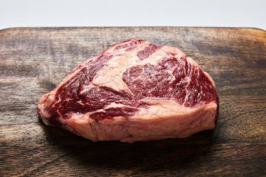 fresh raw steak on wooden cutting board clipart