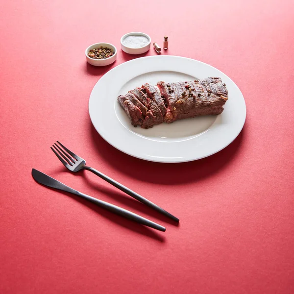 Tasty Grilled Steak Served Plate Cutlery Salt Pepper Bowls Red — Stock Photo, Image