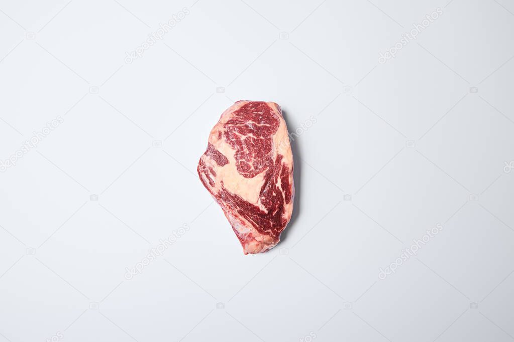 top view of fresh raw steak on on white background
