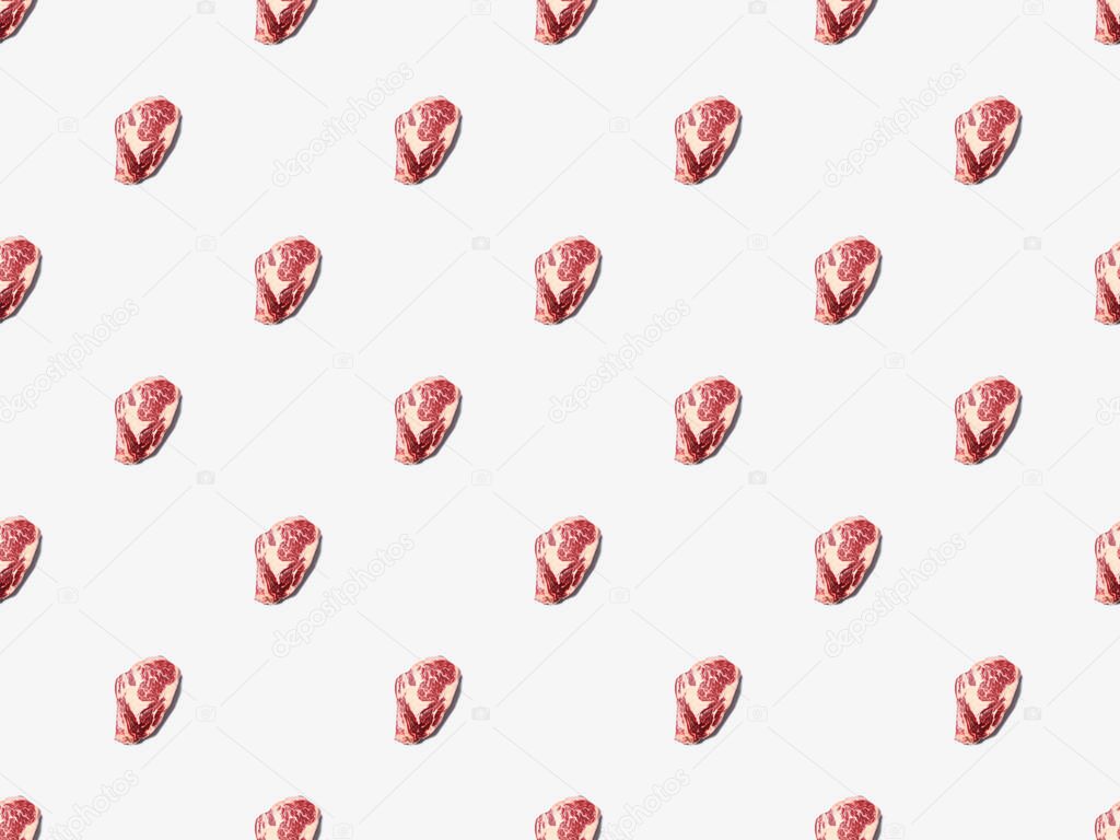 top view of fresh raw steak on on white background, seamless background pattern