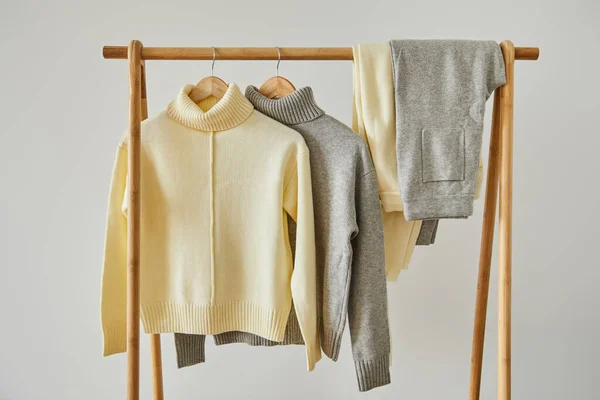 Beige Grey Knitted Soft Sweaters Pants Hanging Wooden Hangers Isolated — Stock Photo, Image