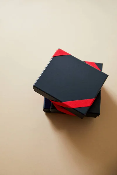 Tilikan Atas Kotak Hadiah Hitam Dengan Pita Merah Latar Beige — Stok Foto