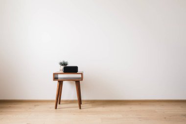 wooden coffee table with plant and clock with blank screen clipart